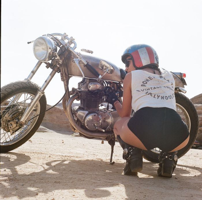 A playful frame from Girls on a motorcycle — online in Kito